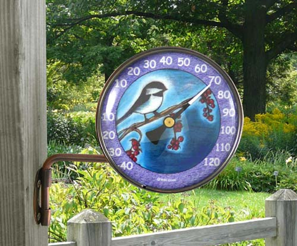 Outdoor thermometer with chickadee design in the garden